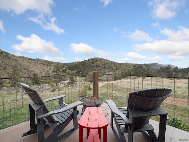 view of patio / terrace with a mountain view and a rural view