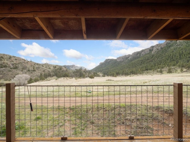 view of yard with a mountain view and a rural view