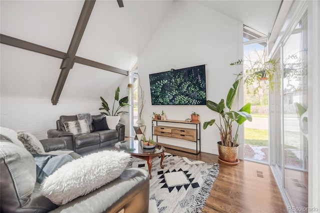 1380 S Dahlia St, Denver, CO 80222 - living room with wood finished floors, visible vents, vaulted ceiling with beams, and baseboards