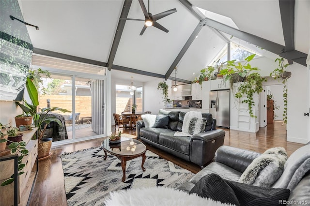 1380 S Dahlia St, Denver, CO 80222 - living room with light wood finished floors, beamed ceiling, high vaulted ceiling, and ceiling fan