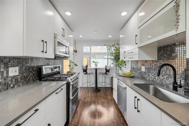 1380 S Dahlia St, Denver, CO 80222 - kitchen with white cabinets, stainless steel appliances, dark wood-style floors, and a sink