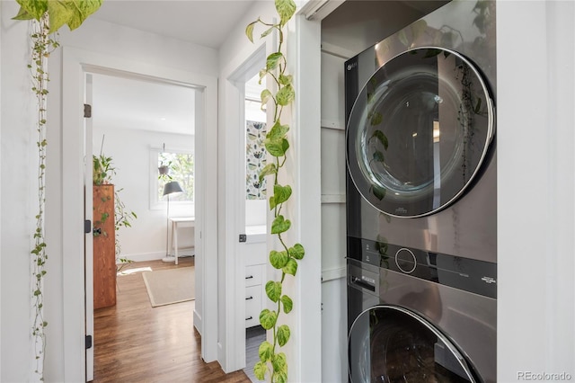 1380 S Dahlia St, Denver, CO 80222 - laundry room featuring stacked washer and clothes dryer, wood finished floors, baseboards, and laundry area