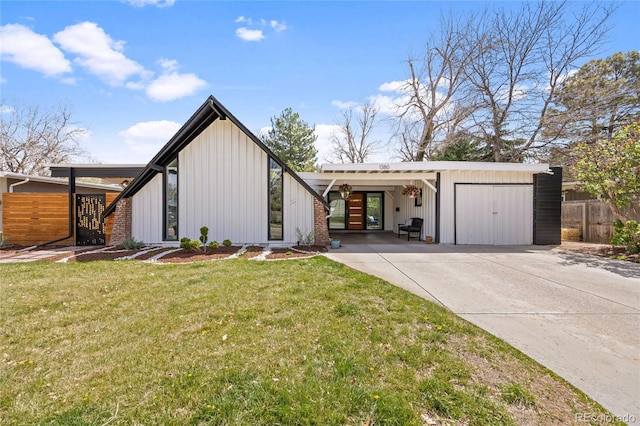 1380 S Dahlia St, Denver, CO 80222 - view of front facade with fence, driveway, a front lawn, and board and batten siding