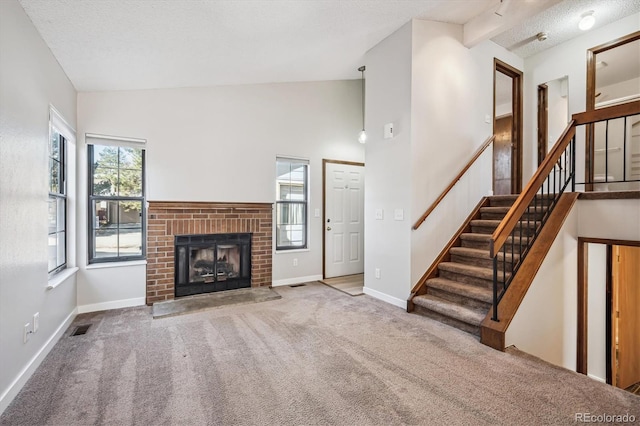 unfurnished living room featuring a textured ceiling, a brick fireplace, carpet flooring, and baseboards