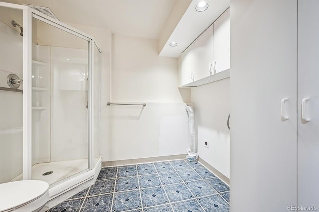 full bath with a stall shower, tile patterned floors, toilet, and recessed lighting