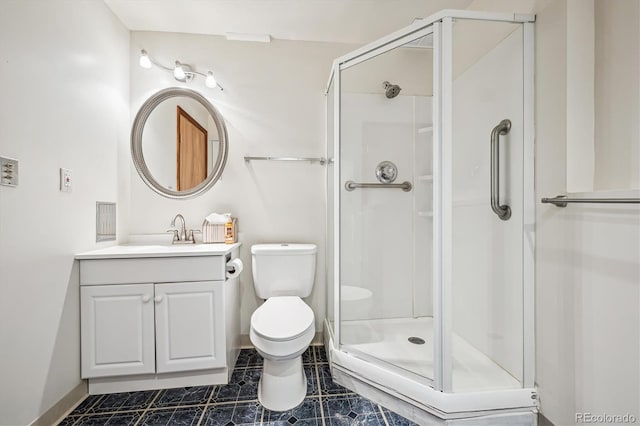 bathroom with toilet, a stall shower, and vanity