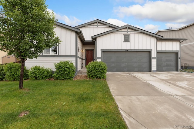 1108 Huntington Ave, Dacono, CO 80514 - view of front of house featuring an attached garage, a front lawn, driveway, and board and batten siding