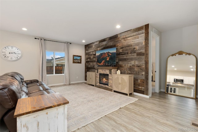 1108 Huntington Ave, Dacono, CO 80514 - living area featuring a glass covered fireplace, light wood finished floors, recessed lighting, and an accent wall