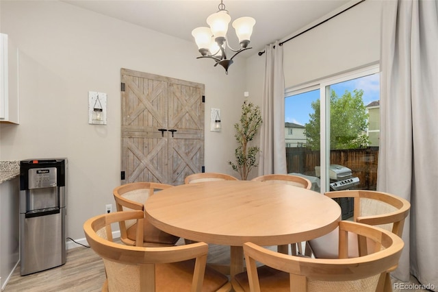 1108 Huntington Ave, Dacono, CO 80514 - dining room featuring a chandelier and light wood-style floors
