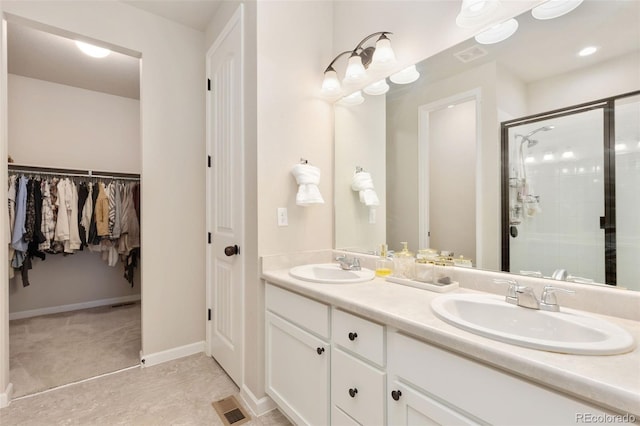 1108 Huntington Ave, Dacono, CO 80514 - bathroom featuring double vanity, a stall shower, and a walk in closet