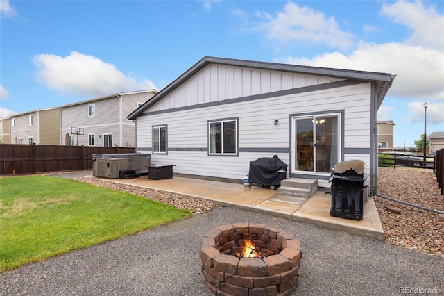 1108 Huntington Ave, Dacono, CO 80514 - rear view of house featuring a hot tub, an outdoor fire pit, a patio, and a fenced backyard