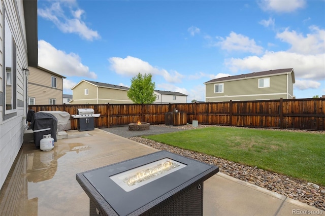 1108 Huntington Ave, Dacono, CO 80514 - fenced backyard featuring an outdoor fire pit, a patio, and a grill
