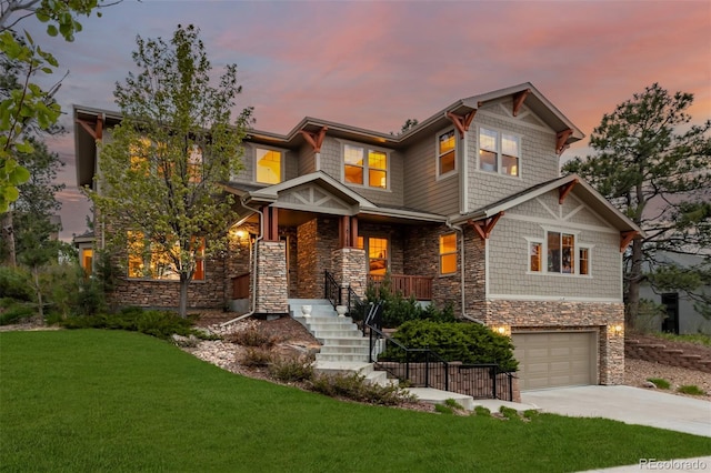 craftsman-style house with a garage, a lawn, and covered porch