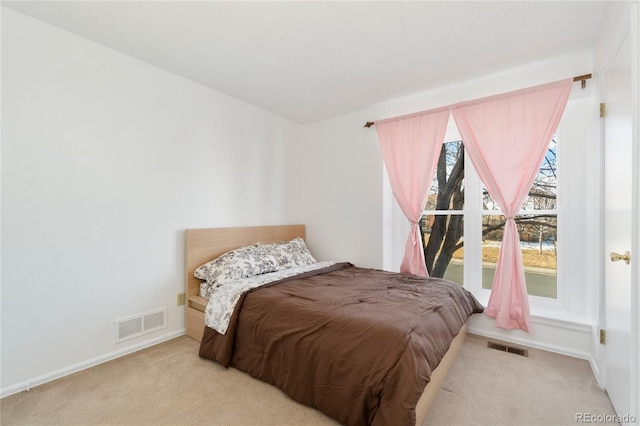 bedroom with light colored carpet