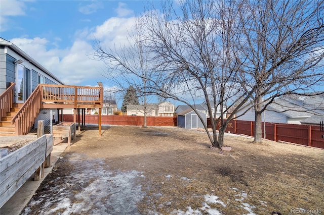 view of yard with a wooden deck and a shed