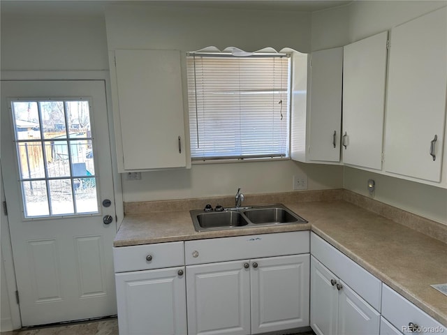 11549 Frederick St, Fort Lupton, CO 80621 - kitchen with a sink, white cabinetry, and light countertops