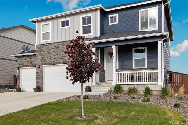 353 Raven Ln, Johnstown, CO 80534 - view of front of property with stone siding, a garage, concrete driveway, a porch, and board and batten siding