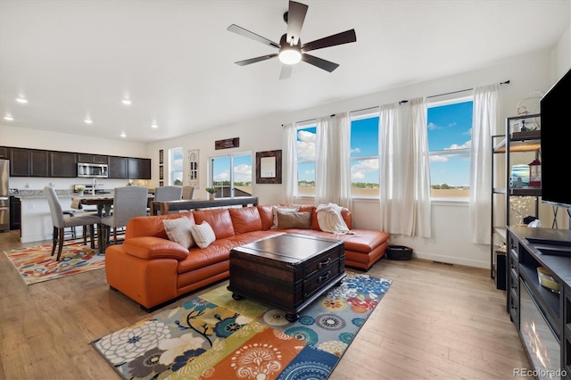 353 Raven Ln, Johnstown, CO 80534 - living area with light wood-style floors, a ceiling fan, recessed lighting, and baseboards