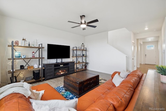 353 Raven Ln, Johnstown, CO 80534 - living room with a ceiling fan, wood finished floors, baseboards, and a glass covered fireplace