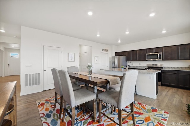 353 Raven Ln, Johnstown, CO 80534 - dining area featuring light wood finished floors and recessed lighting