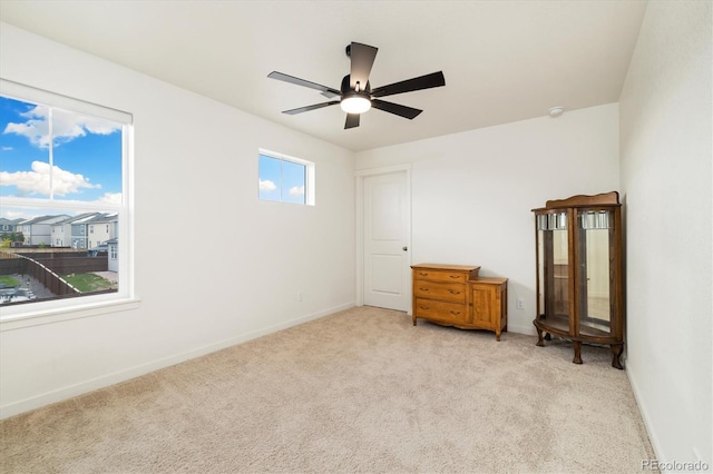 353 Raven Ln, Johnstown, CO 80534 - unfurnished bedroom with light colored carpet, baseboards, and ceiling fan