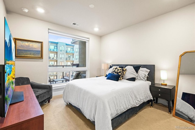 bedroom featuring light colored carpet