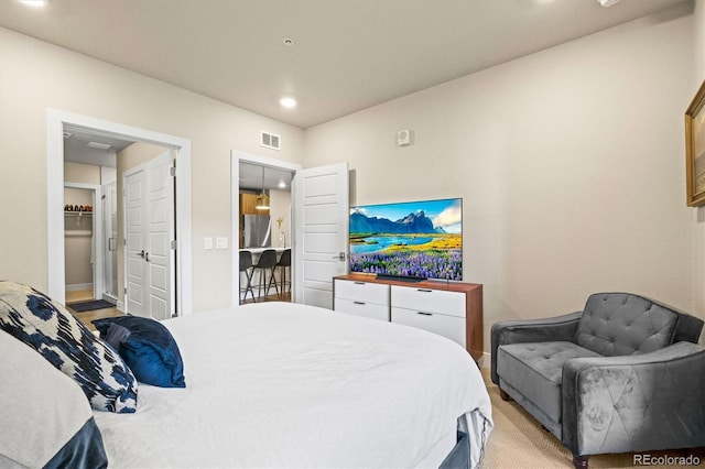 bedroom featuring stainless steel fridge