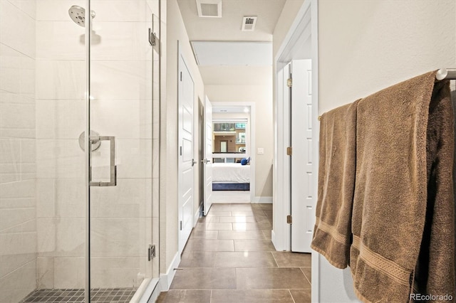 bathroom featuring an enclosed shower and tile patterned flooring