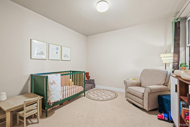 carpeted bedroom with a nursery area