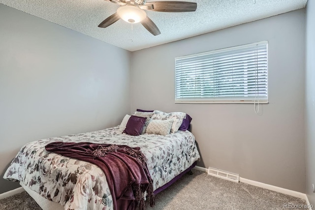 carpeted bedroom featuring a textured ceiling and ceiling fan