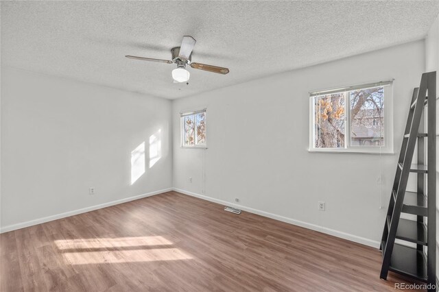 unfurnished room with ceiling fan, baseboards, and wood finished floors