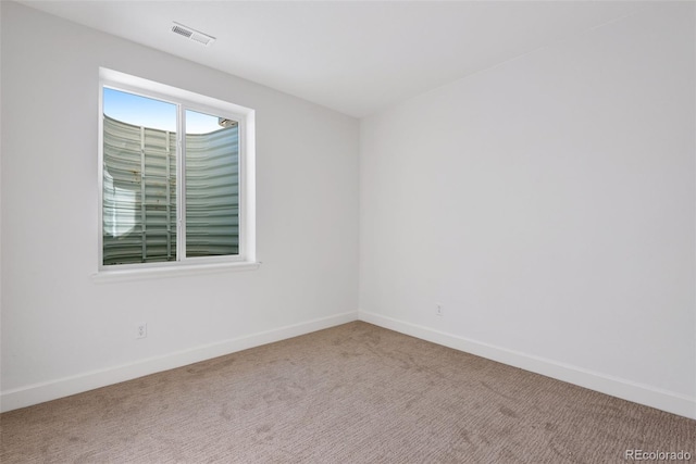 empty room featuring light carpet