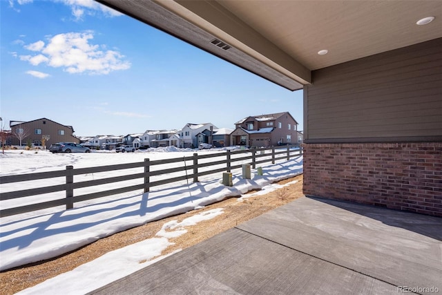 snow covered patio featuring a balcony