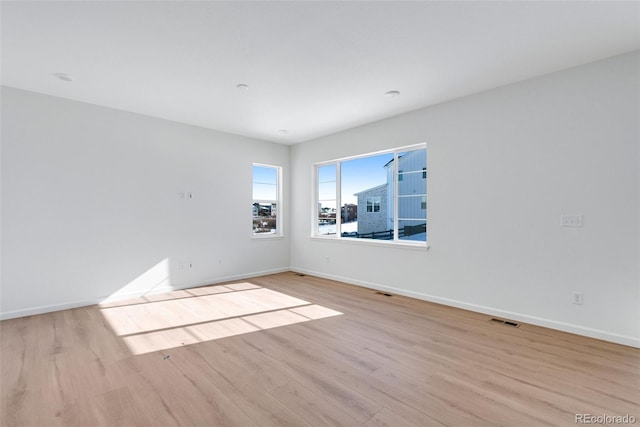 spare room with light hardwood / wood-style floors