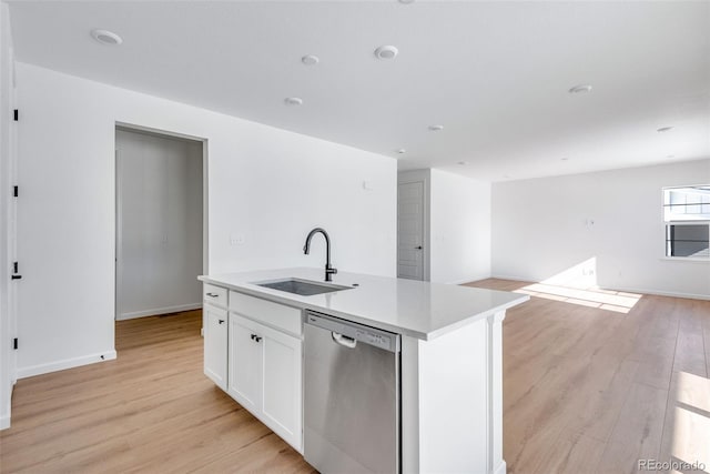 kitchen with white cabinetry, sink, stainless steel dishwasher, an island with sink, and light wood-type flooring