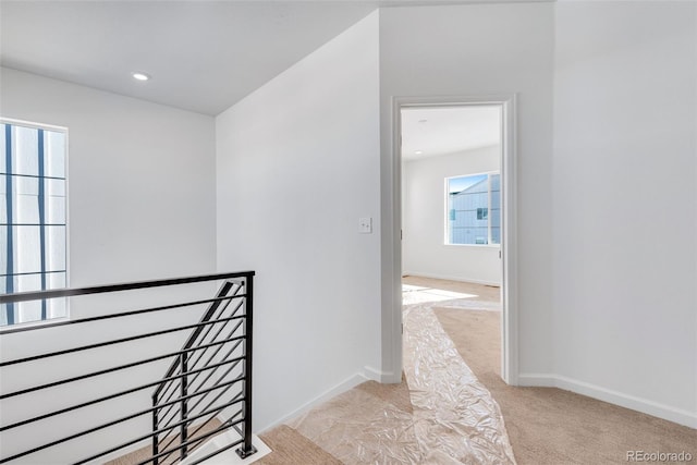 hallway with light colored carpet