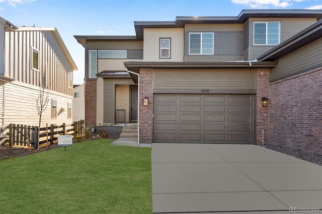 view of front of house featuring a garage and a front yard