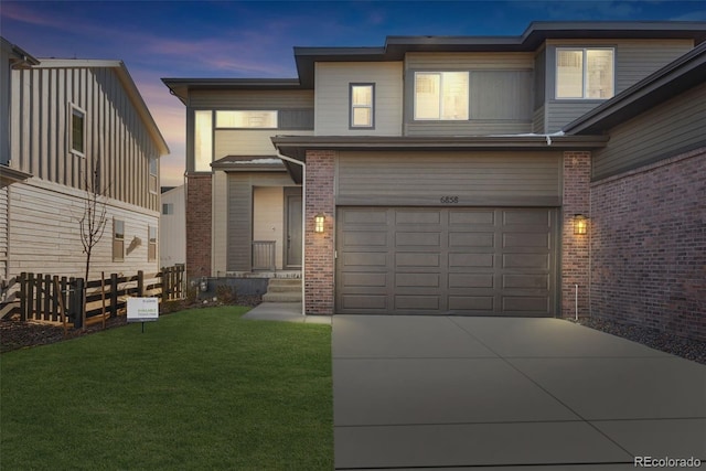 view of front of house with a yard and a garage