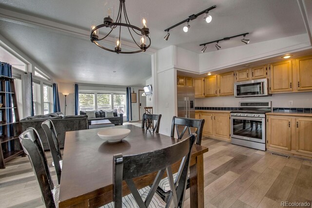 492 Kimmes Ln, Breckenridge, CO 80424 - dining room featuring a chandelier and light wood-type flooring