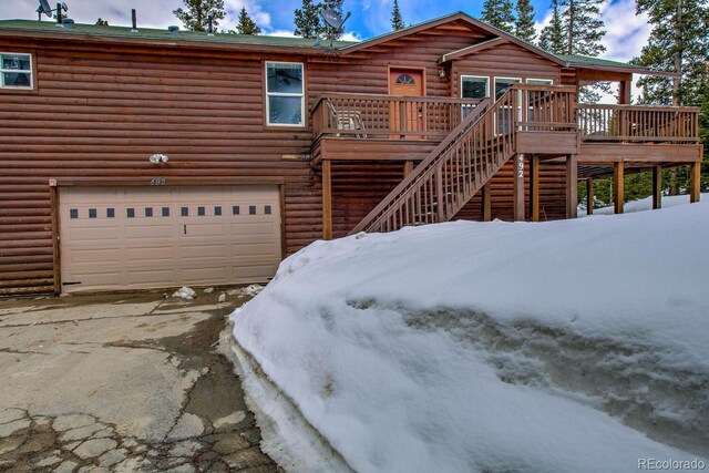 492 Kimmes Ln, Breckenridge, CO 80424 - view of front of property with an attached garage, concrete driveway, a wooden deck, and stairs