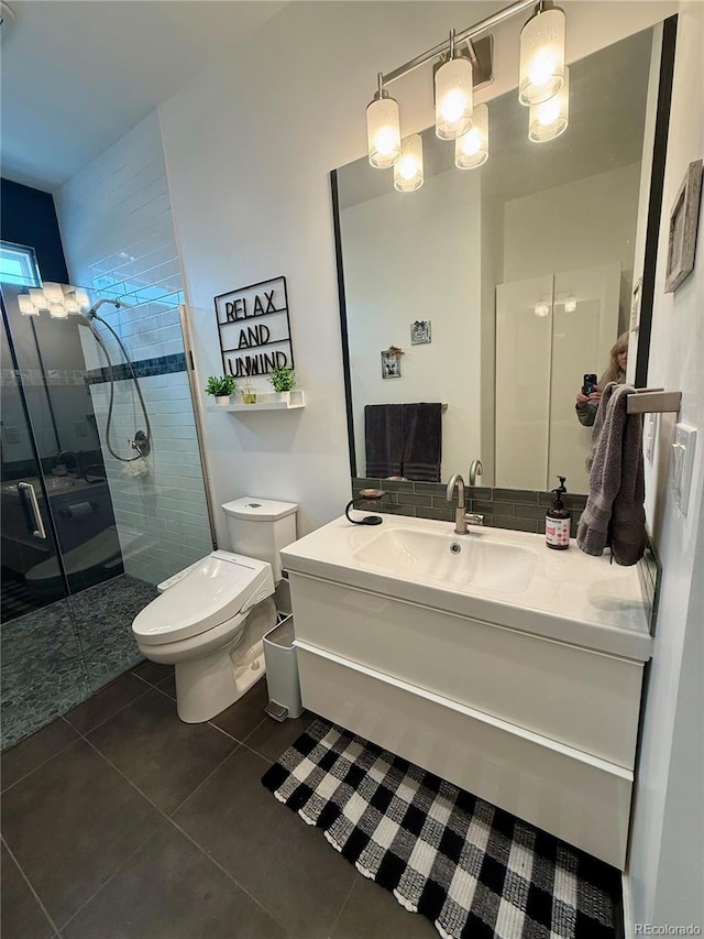 653 Glenarbor Cir, Longmont, CO 80504 - full bathroom featuring toilet, tile patterned floors, a shower stall, and vanity