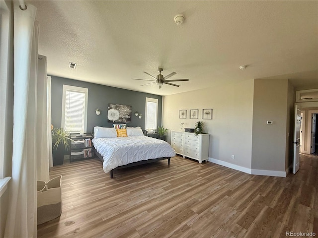 653 Glenarbor Cir, Longmont, CO 80504 - bedroom with wood finished floors, a textured ceiling, baseboards, and a ceiling fan