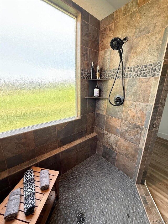 653 Glenarbor Cir, Longmont, CO 80504 - full bathroom with a tile shower and wood finished floors