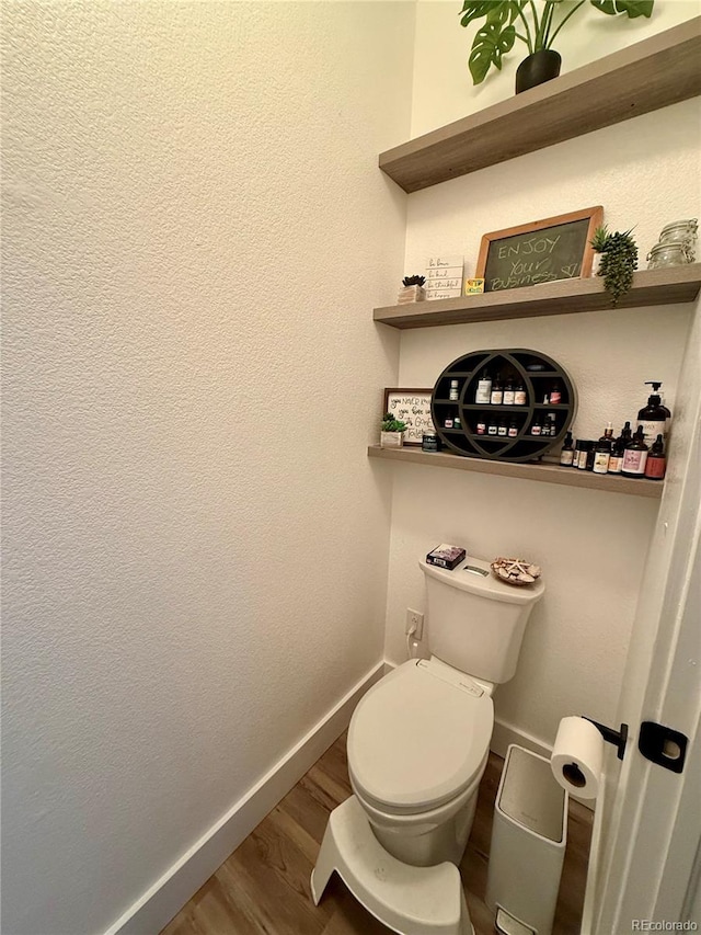 653 Glenarbor Cir, Longmont, CO 80504 - bathroom with baseboards, wood finished floors, and toilet