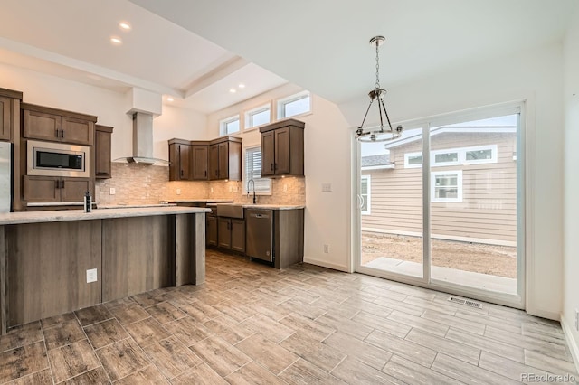6261 Red Cedar St, Frederick, CO 80530 - kitchen featuring a sink, wall chimney exhaust hood, visible vents, appliances with stainless steel finishes, and tasteful backsplash