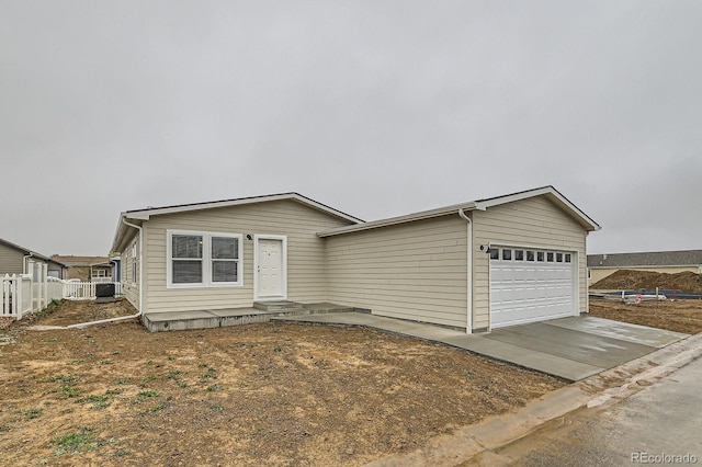 6261 Red Cedar St, Frederick, CO 80530 - view of front of house featuring driveway, an attached garage, and fence