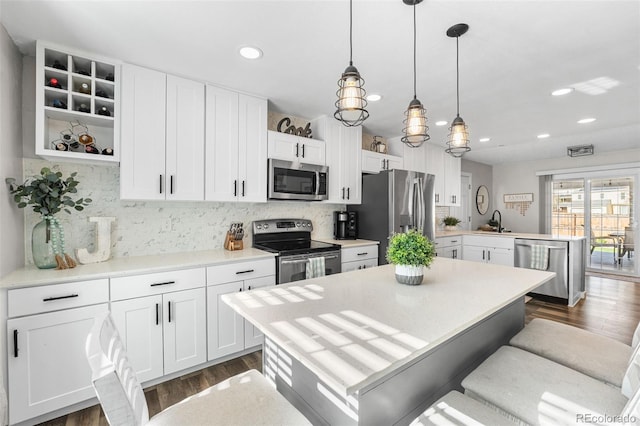 4733 S Vivian Ct, Morrison, CO 80465 - kitchen featuring stainless steel appliances, a peninsula, a sink, recessed lighting, and decorative backsplash