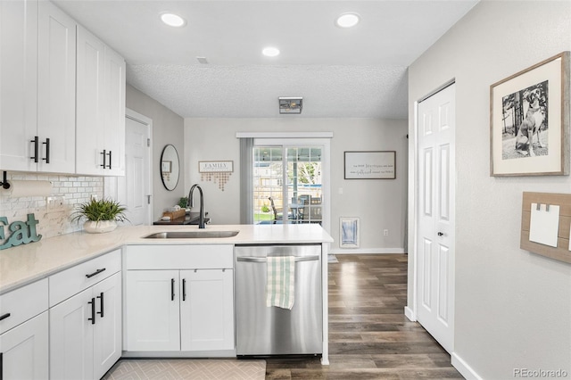 4733 S Vivian Ct, Morrison, CO 80465 - kitchen with stainless steel dishwasher, a sink, a peninsula, white cabinets, and recessed lighting