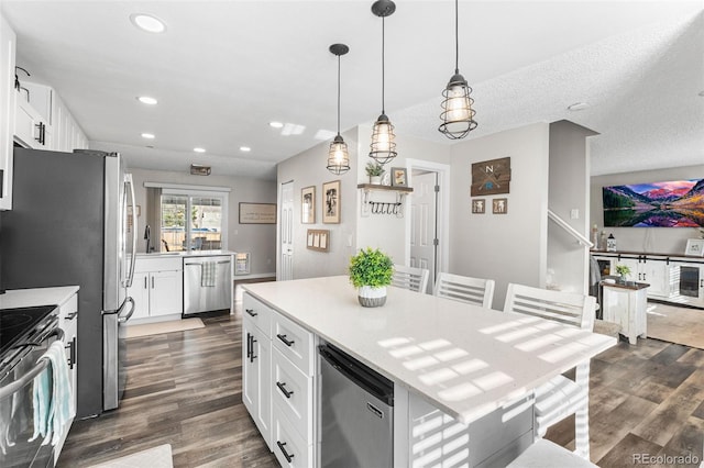 4733 S Vivian Ct, Morrison, CO 80465 - kitchen featuring stainless steel appliances, dark wood-style floors, light countertops, white cabinetry, and recessed lighting