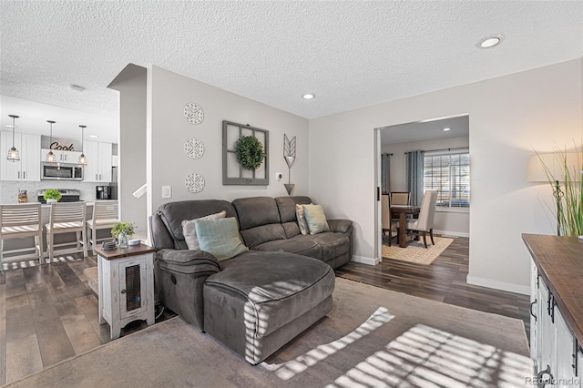 4733 S Vivian Ct, Morrison, CO 80465 - living room with dark wood finished floors, recessed lighting, a textured ceiling, and baseboards